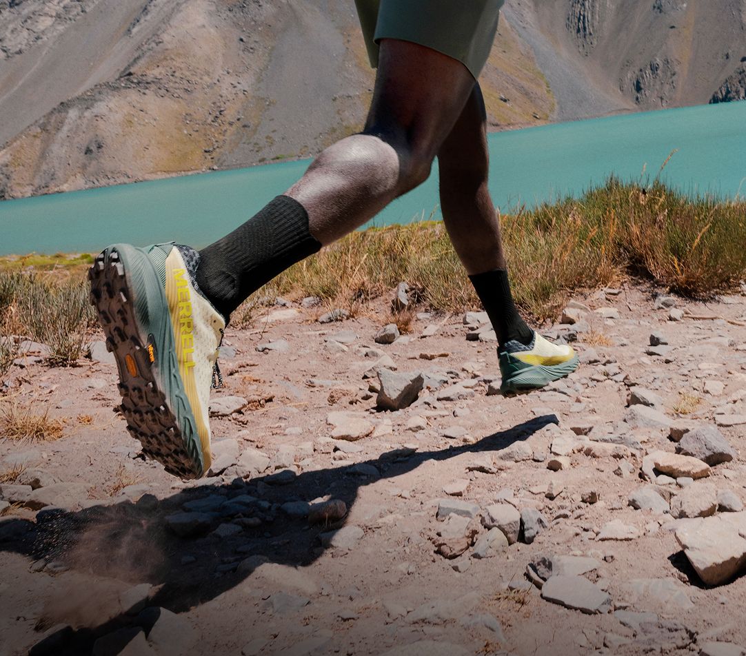 Person tying Merrell running shoes